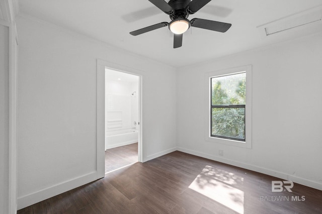 spare room featuring ceiling fan and dark hardwood / wood-style floors