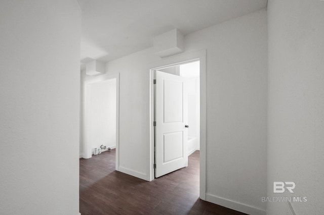 corridor featuring dark hardwood / wood-style floors