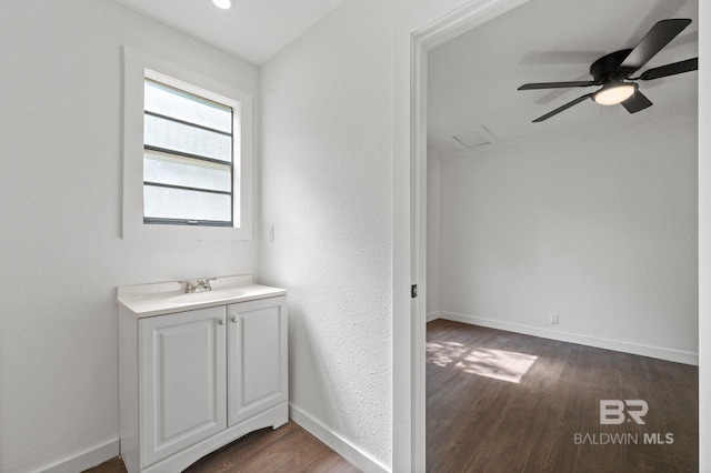 bathroom featuring hardwood / wood-style flooring, ceiling fan, and vanity