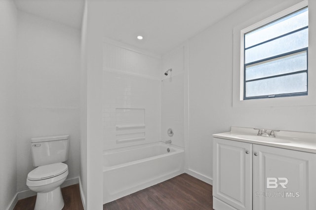 full bathroom with hardwood / wood-style floors, vanity, toilet, and  shower combination