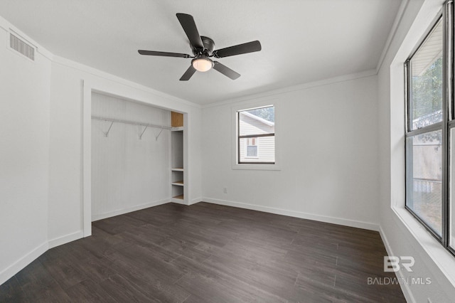 unfurnished bedroom with multiple windows, ceiling fan, a closet, and dark hardwood / wood-style flooring