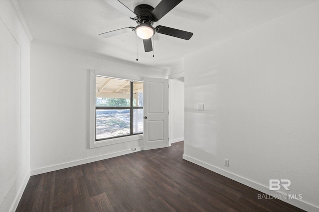 spare room with ceiling fan and dark hardwood / wood-style flooring