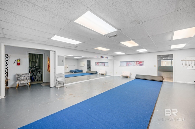 exercise room featuring a drop ceiling