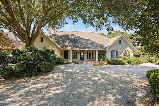 single story home with covered porch and stucco siding