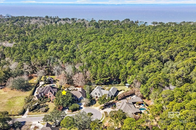 birds eye view of property featuring a forest view and a residential view