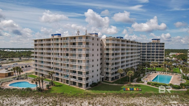 view of building exterior with a community pool