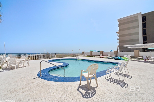 community pool featuring a patio area and fence