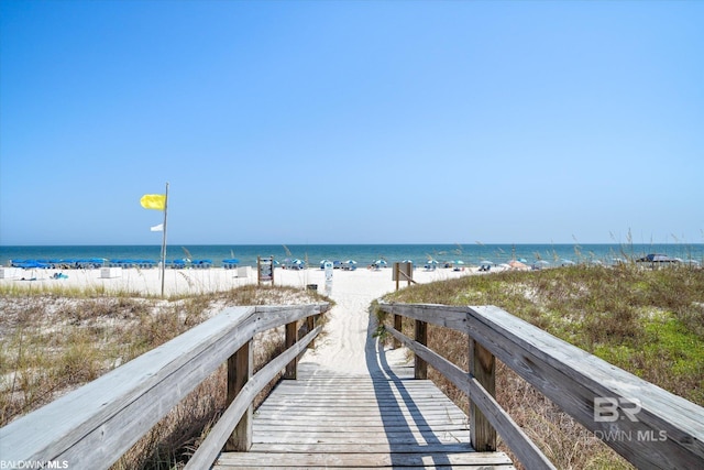 view of home's community with a beach view and a water view