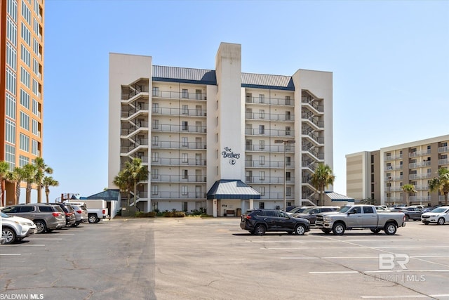 view of building exterior with uncovered parking