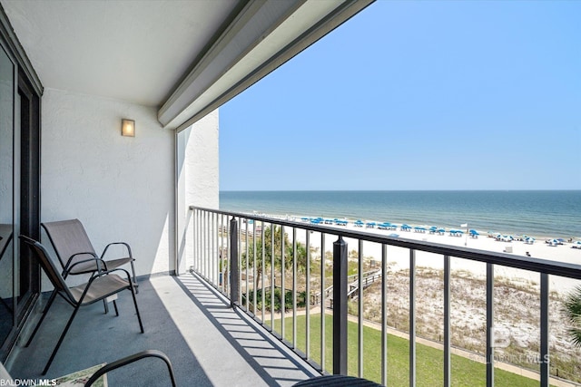 balcony with a view of the beach and a water view