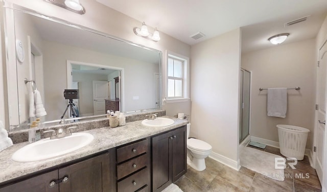 11116 Sturbridge Loop, Daphne, AL 36526 - full bathroom featuring double vanity, a shower stall, toilet, and baseboards