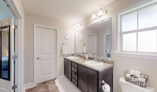11116 Sturbridge Loop, Daphne, AL 36526 - bathroom featuring double vanity, toilet, and baseboards