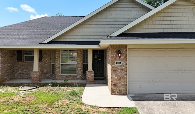 11116 Sturbridge Loop, Daphne, AL 36526 - property entrance with brick siding, a garage, and roof with shingles