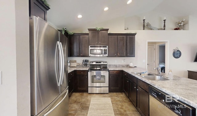 11116 Sturbridge Loop, Daphne, AL 36526 - kitchen with stainless steel appliances, vaulted ceiling, dark brown cabinetry, light countertops, and a peninsula