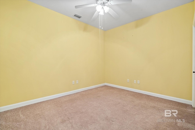 carpeted spare room with ceiling fan