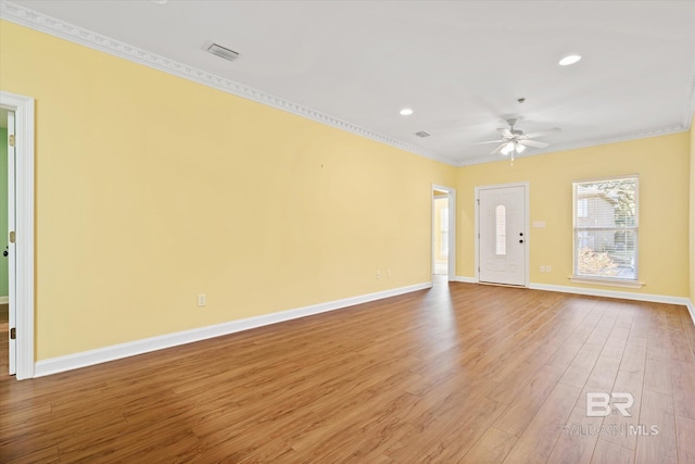 unfurnished room featuring ceiling fan, hardwood / wood-style floors, and crown molding