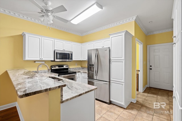 kitchen with light stone countertops, white cabinets, appliances with stainless steel finishes, kitchen peninsula, and light tile patterned floors