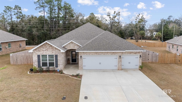 view of front of property with a garage and a front lawn