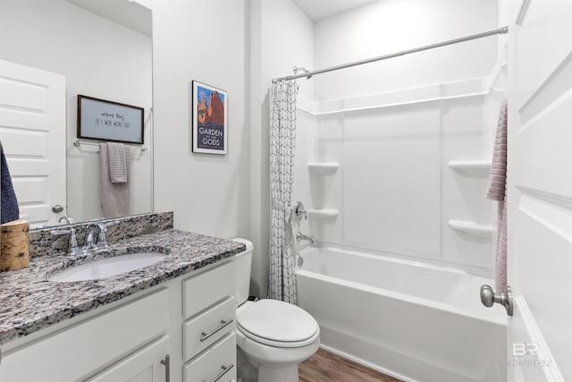 full bathroom with vanity, hardwood / wood-style flooring, toilet, and shower / bath combo with shower curtain