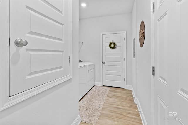 doorway to outside featuring separate washer and dryer and light hardwood / wood-style floors