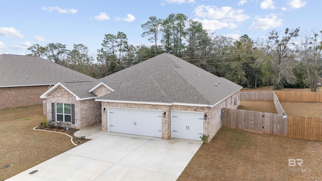 view of front of property with a garage and a front lawn