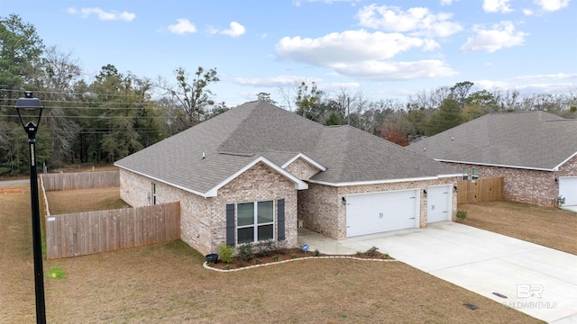 view of front of house with a garage and a front lawn