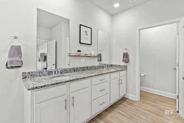 bathroom featuring vanity and hardwood / wood-style floors