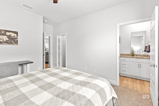 carpeted bedroom featuring ensuite bathroom and ceiling fan