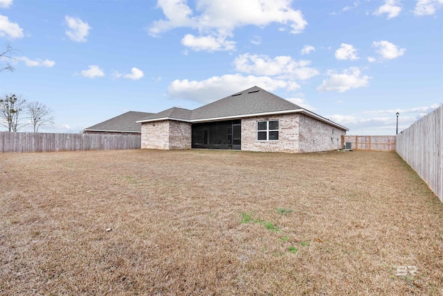 back of house featuring a yard