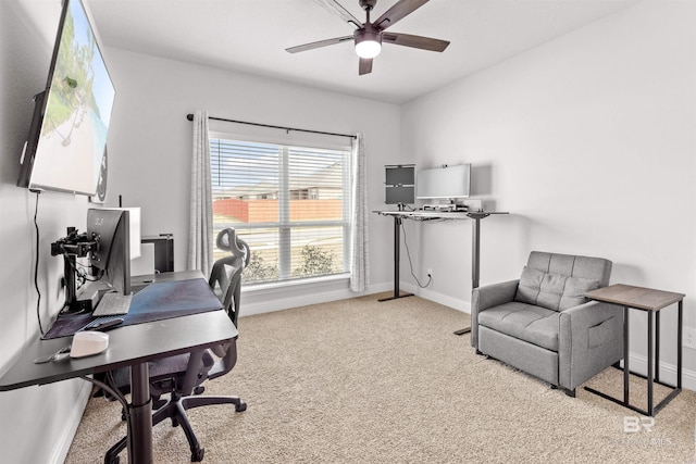 office area featuring light carpet and ceiling fan