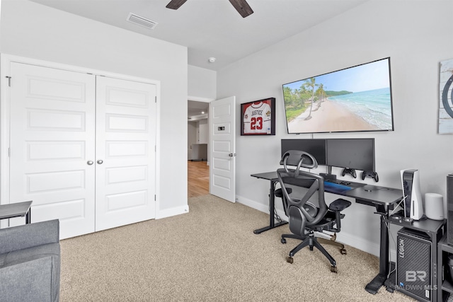 carpeted office featuring ceiling fan