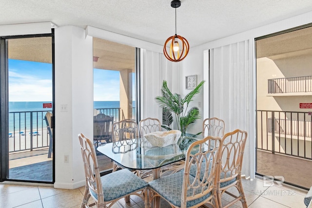 24400 Perdido Beach Blvd Unit 501, Orange Beach, AL 36561 - dining space featuring a wealth of natural light, a textured ceiling, a wall of windows, and light tile patterned floors
