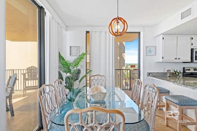 24400 Perdido Beach Blvd Unit 501, Orange Beach, AL 36561 - dining room with a textured ceiling and visible vents