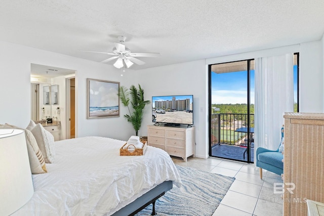 24400 Perdido Beach Blvd Unit 501, Orange Beach, AL 36561 - bedroom with a textured ceiling, ceiling fan, connected bathroom, access to exterior, and light tile patterned floors