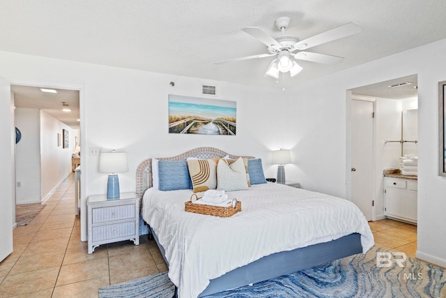 24400 Perdido Beach Blvd Unit 501, Orange Beach, AL 36561 - bedroom featuring a textured ceiling, visible vents, baseboards, a ceiling fan, and light tile patterned floors