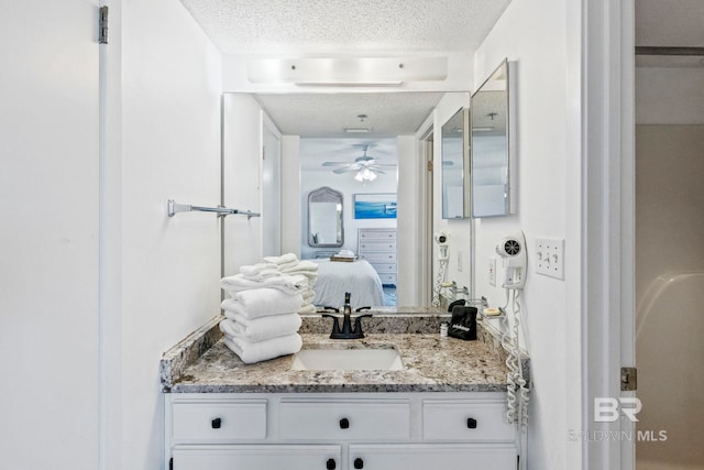 24400 Perdido Beach Blvd Unit 501, Orange Beach, AL 36561 - ensuite bathroom featuring connected bathroom, a ceiling fan, vanity, and a textured ceiling