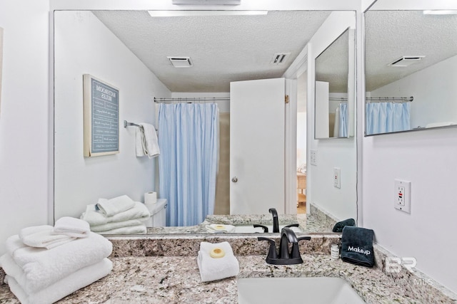 24400 Perdido Beach Blvd Unit 501, Orange Beach, AL 36561 - bathroom featuring a textured ceiling and visible vents