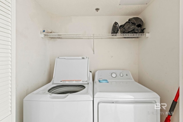 24400 Perdido Beach Blvd Unit 501, Orange Beach, AL 36561 - clothes washing area featuring laundry area, separate washer and dryer, and a textured ceiling