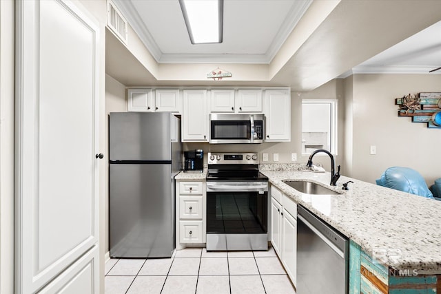 kitchen featuring sink, a tray ceiling, stainless steel appliances, and white cabinets