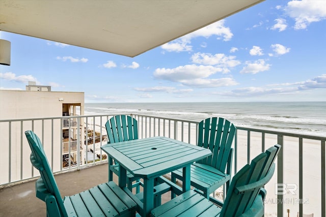 balcony featuring a water view and a beach view