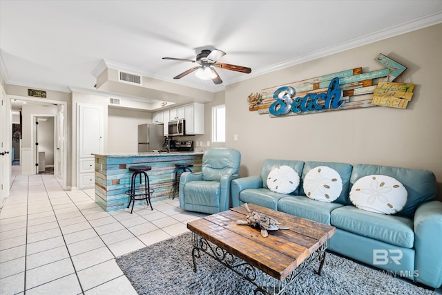 living room with ceiling fan, ornamental molding, and light tile patterned floors