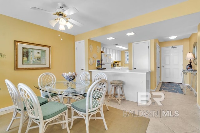 tiled dining area with ceiling fan