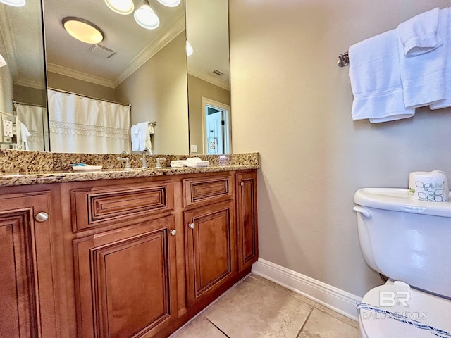 bathroom with toilet, vanity, tile patterned floors, and ornamental molding