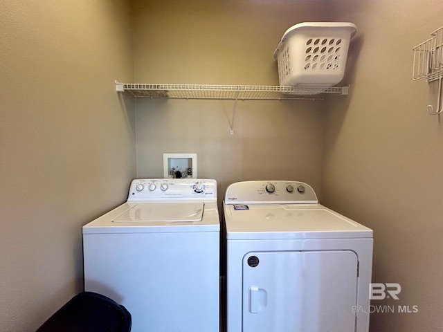 clothes washing area featuring washer and clothes dryer