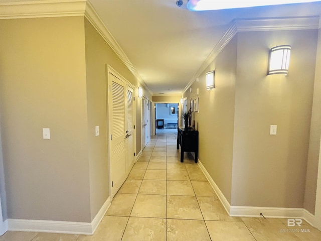 hallway featuring light tile patterned flooring and crown molding