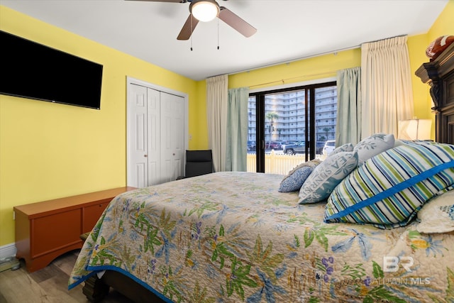 bedroom with a ceiling fan, access to outside, a closet, and wood finished floors