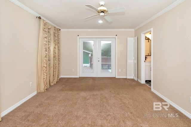 carpeted empty room with crown molding, french doors, and ceiling fan