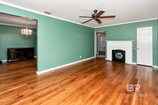 unfurnished living room with ornamental molding, ceiling fan with notable chandelier, and wood-type flooring