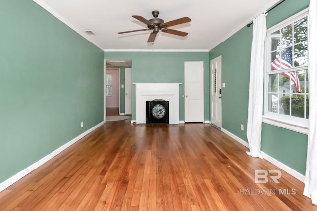 unfurnished living room with hardwood / wood-style floors, ceiling fan, and a healthy amount of sunlight