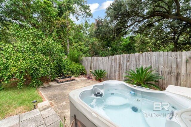 view of pool with a hot tub